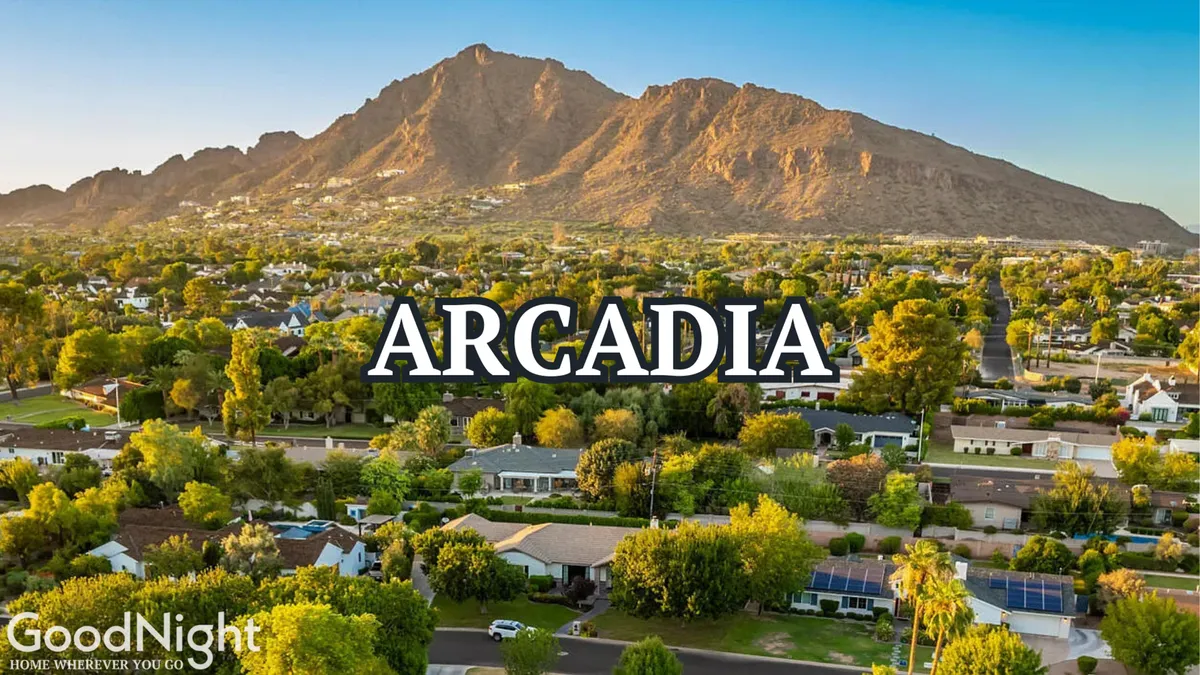 A peaceful neighborhood scene with mountains in the background, mature trees, and homes nestled among the greenery. The tranquil environment suggests access to local parks, walking paths, and community spaces ideal for outings with pets.