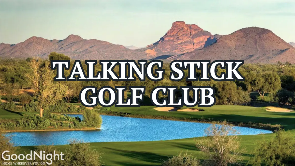 A lush golf course unfolds under clear skies, with a tranquil lake and a dramatic mountain backdrop. Manicured greens and fairways hint at premier local golf experiences.
